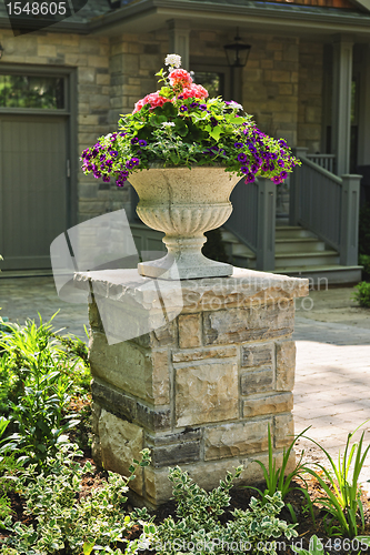 Image of Stone planter in front of house