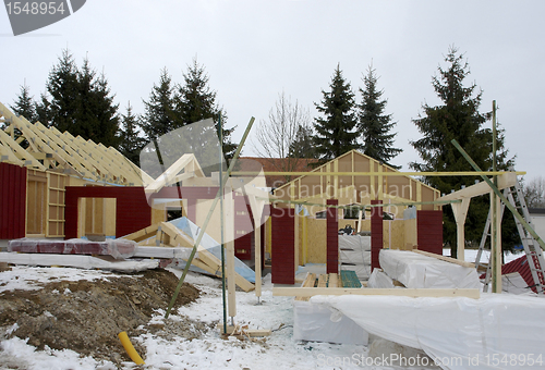 Image of wooden house construction at winter time