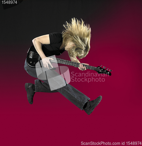 Image of jumping bass guitar woman