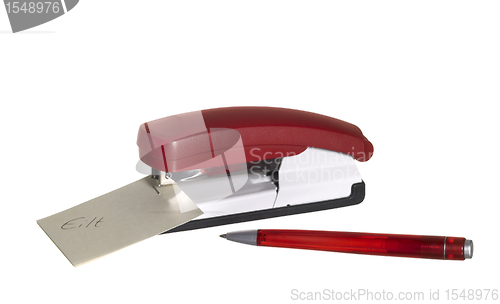 Image of red stapler with paper and pen
