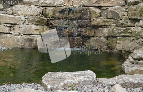 Image of stone wall and pond detail