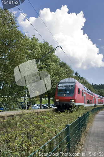 Image of red train in sunny ambiance