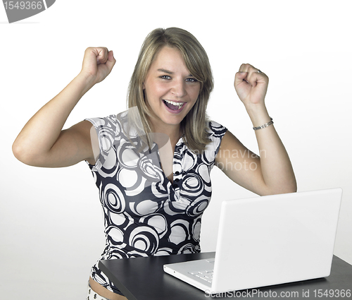 Image of laughing cute blond girl with laptop in light back