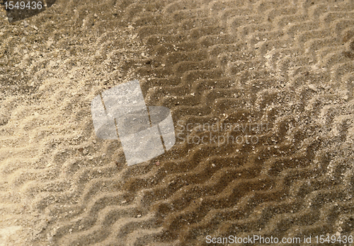 Image of wavy lines on brown sand surface