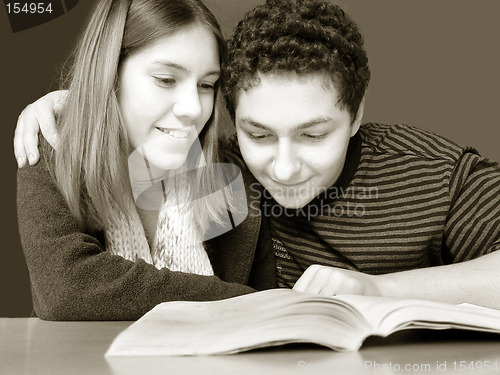 Image of 2 teenagers reading a book