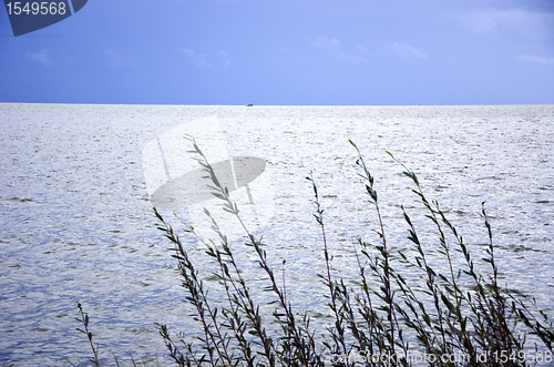 Image of Calm sea sky landscape ship sailing in distance 