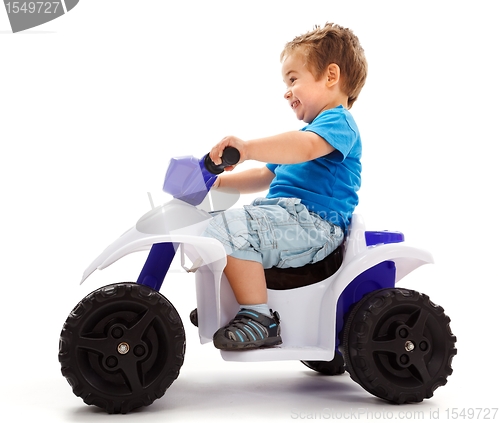 Image of Little boy going fast with quad