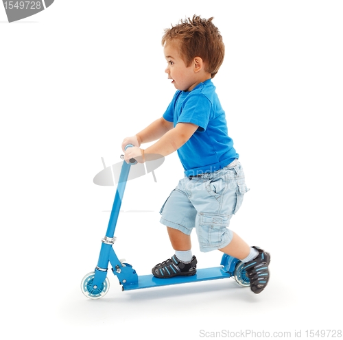Image of Boy playing with blue toy scooter