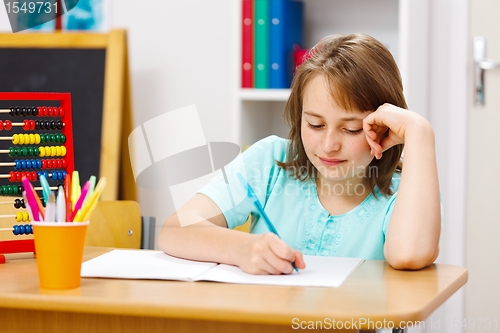 Image of Schoolgirl writing homework