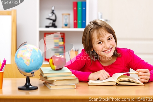 Image of Schoolgirl reading in classroom