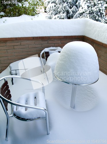 Image of Table and chairs covered in snow