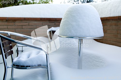 Image of Table and chairs covered in snow