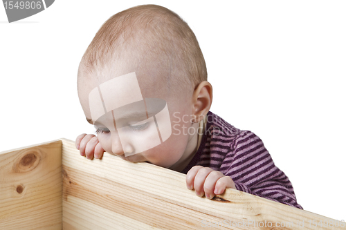 Image of baby looking into wooden box