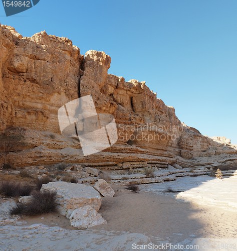 Image of Wall of desert canyon at sunset