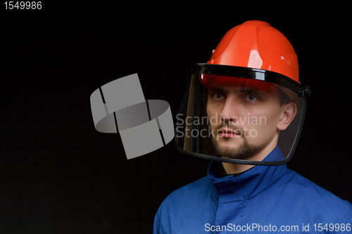 Image of The worker in overalls and a helmet