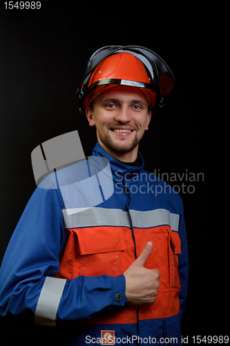 Image of The worker in overalls and a helmet