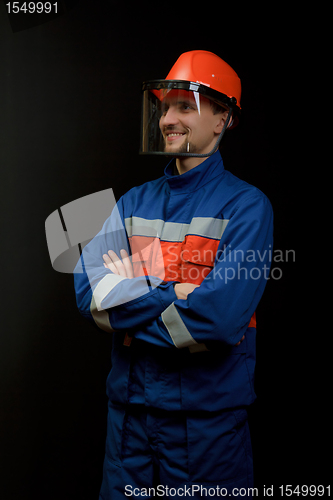 Image of The worker in overalls and a helmet