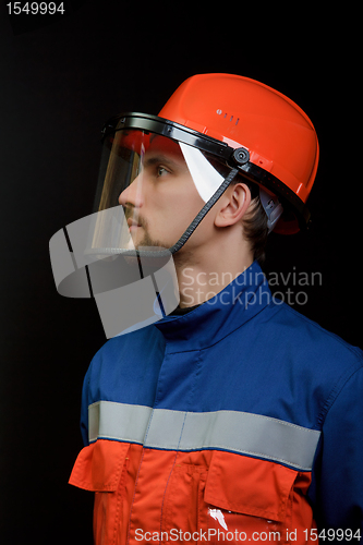 Image of The worker in overalls and a helmet