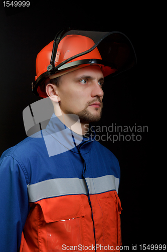 Image of The worker in overalls and a helmet