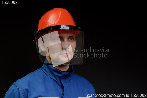 Image of The worker in overalls and a helmet