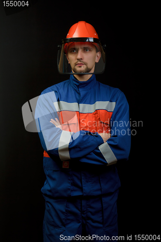 Image of The worker in overalls and a helmet