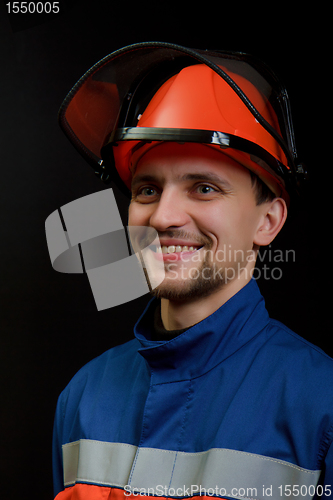 Image of The worker in overalls and a helmet