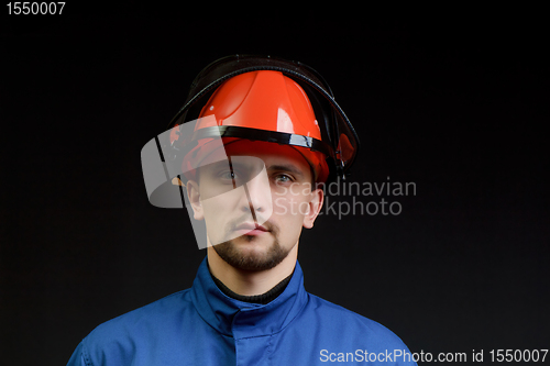 Image of The worker in overalls