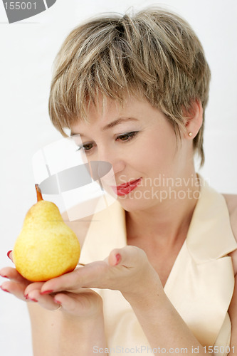 Image of Funny girl holding a pear