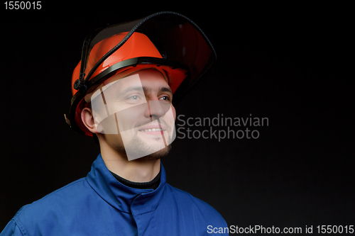 Image of The worker in overalls and a helmet