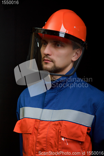 Image of The worker in overalls and a helmet