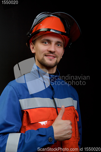 Image of The worker in overalls and a helmet