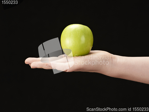 Image of Childs hand with apple in palm