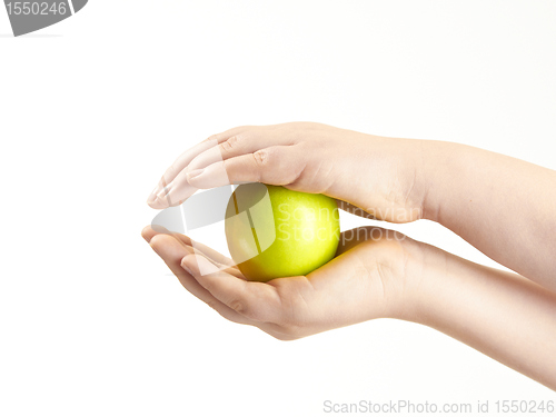 Image of Apple sandwiched between childs hands