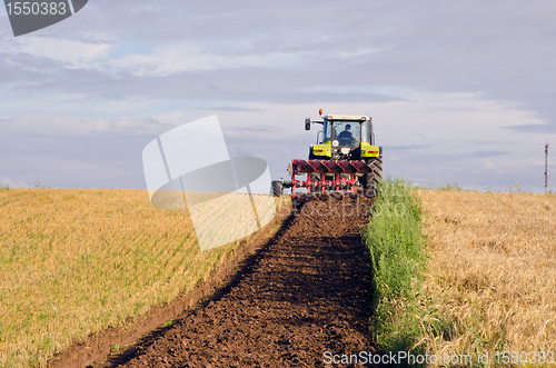 Image of Tractor plow agricultural field harvested land 