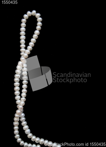 Image of White pearls on the black silk