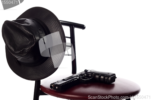 Image of Gun and hat on the chair