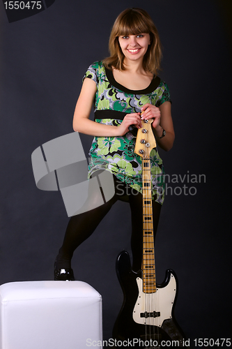 Image of Young beautiful girl with a guitar