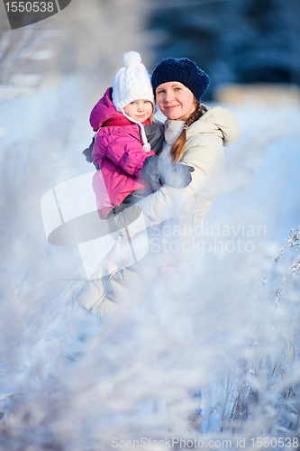 Image of Mother and daughter outdoors at winter
