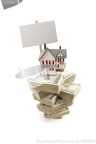 Image of Small House on Stacks of Hundred Dollar Bills and Blank Sign