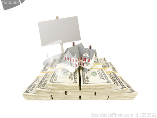 Image of Small House on Stacks of Hundred Dollar Bills and Blank Sign