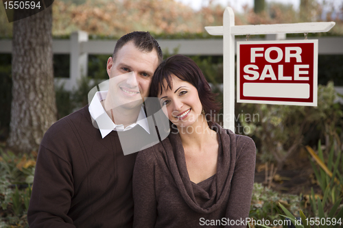 Image of Happy Couple in Front of Real Estate Sign