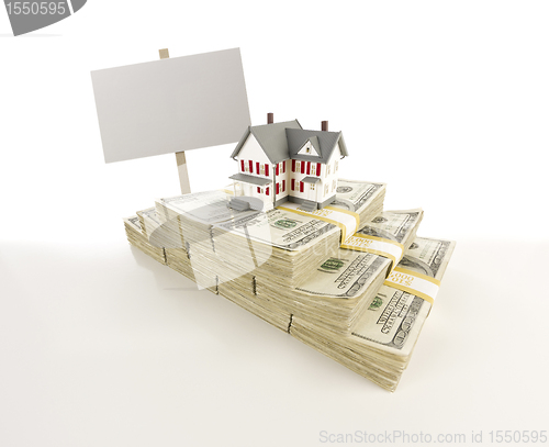 Image of Small House on Stacks of Hundred Dollar Bills and Blank Sign