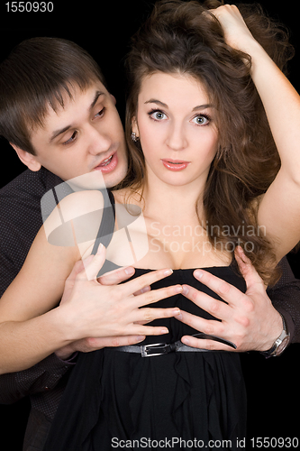 Image of Handsome man holding woman