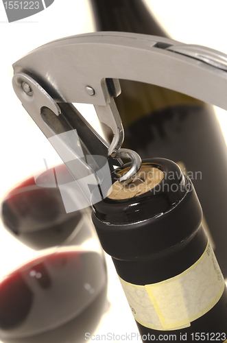Image of Corkscrew opening wine bottle 