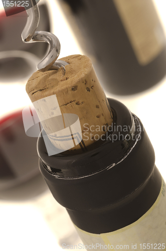 Image of Corkscrew opening wine bottle 