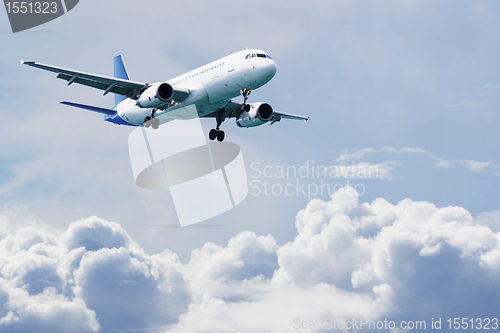 Image of Passenger airliner flies above the clouds