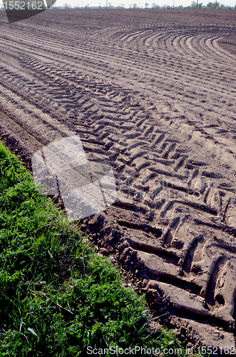 Image of Leveled agricultural field truck wheel mark ground 