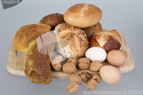 Image of gem, nuts and eggs on a wooden board