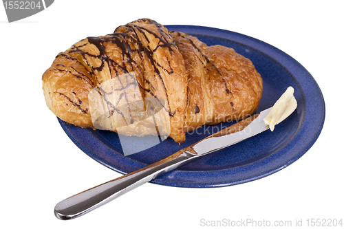 Image of croissant on blue dish