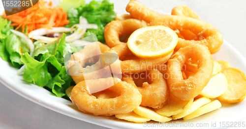 Image of Deep batter fried squid rings calamari with green salad 
